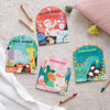 Petit Collage’s “Coloring Book With Stickers: Mermaids” is displayed on a light surface with colored pencils beside it.