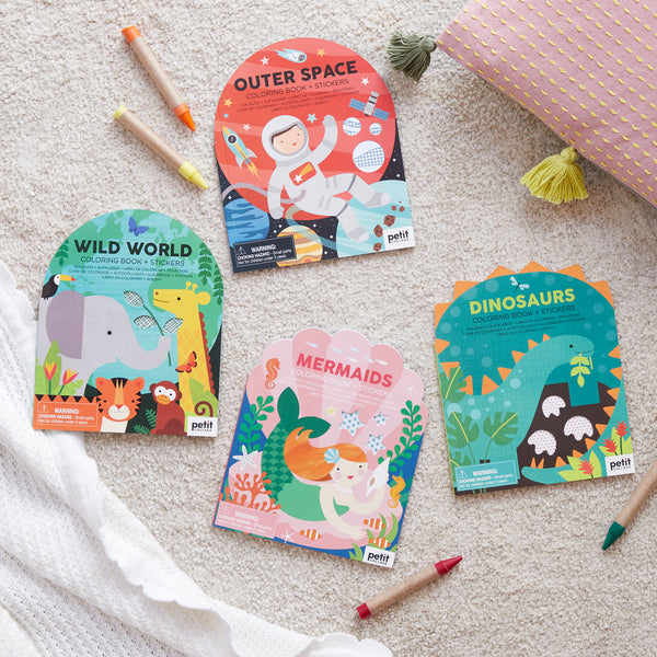 Petit Collage’s “Coloring Book With Stickers: Mermaids” is displayed on a light surface with colored pencils beside it.