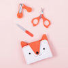 The Petit Collage Baby Manicure Kit is a small orange and white purse with a cat face and scissors.