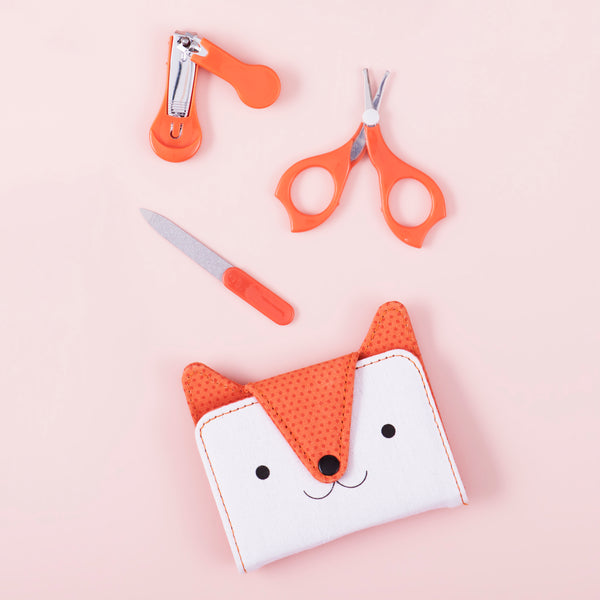 The Petit Collage Baby Manicure Kit is a small orange and white purse with a cat face and scissors.