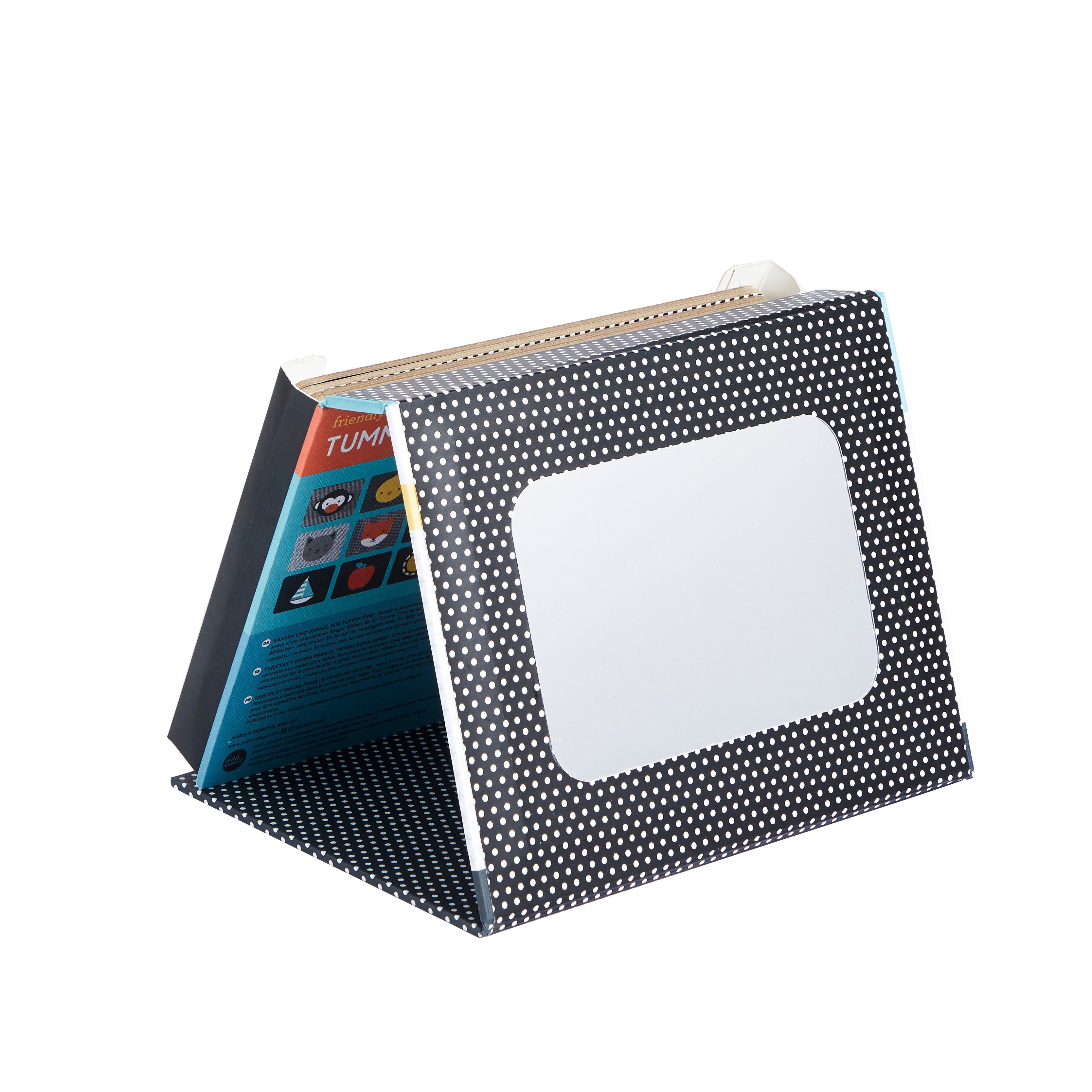 The Petit Collage Tummy Time Peekaboo is a black flip chart with white dots and a blank white rectangle on the front cover, shown standing upright on a white background.