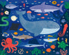 Vibrant illustration of sea creatures—whale, shark, fish, octopus, squid, turtle, jellyfish, and seaweed—set in a deep blue ocean features on the Petit Collage Two Sided Under The Sea On-The-Go Puzzle.