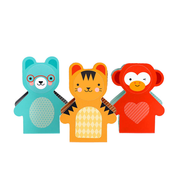 Three colorful, cartoon-style gift boxes from Petit Collage’s Petit Friends Puppet Theatre Set—a blue bear, yellow tiger, and red monkey—stand side by side on a white background.