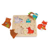 The Petit Collage Reveal Puzzle: You Are My Baby is a wooden animal puzzle with removable bear, rabbit, owl, and fox pieces that fit into matching slots on a square board.