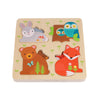 The Reveal Puzzle: You Are My Baby by Petit Collage is a wooden animal puzzle board featuring removable bunny, owl, bear, and fox pieces set against a background decorated with small green plants.