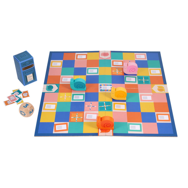 Snail Express by Petit Collage is a colorful board game featuring four snail-shaped pieces in pink, yellow, orange, and blue, a checkered path, wooden die, tokens, and a stack of cards.