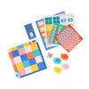 Snail Express by Petit Collage features a multicolored grid board, snail-shaped cardboard cutouts, number tokens, illustrated stamp sheets, and a blue card box—colorfully arranged on a white background.