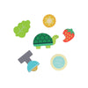 Six flat, colorful shapes inspired by the Petit Collage Petit Pals: Tilly Tortoise set are arranged on a white background, featuring a turtle, leaf, yellow flower, bitten strawberry, lamp, and round blue dish.