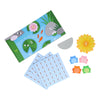 Leaping Frogs! by Petit Collage includes a pond game board, three blue cards, a yellow flower card with the number 5, a gray semi-circle, and four frog tokens in blue, pink, and green.