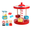 The Petit Collage Merry-Go-Round Wooden Carousel is a colorful circus-themed toy set featuring a red and white carousel with three seats, three animal figurines, two ticket booths, and several rectangular tickets.