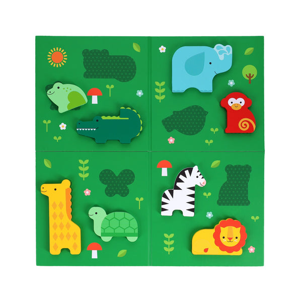 The First Bingo Game: Animal Friends by Petit Collage features a green board with animal-shaped pieces—elephant, frog, monkey, crocodile, giraffe, turtle, zebra, and lion—decorated with plants, flowers, and mushrooms.