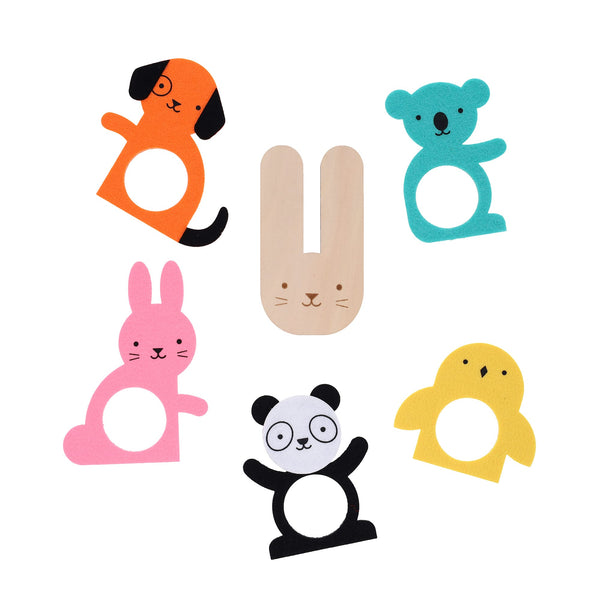 Six pom-pom animal finger puppets from Petit Collage’s Creature Crafts: My Pom-Pom Friends kit—including dog, bear, bunny, panda, chick, and a wooden bunny—are arranged in a circle on a white background.