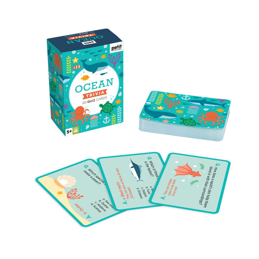 The Petit Collage Ocean Trivia set includes a box, a stack of quiz cards, and four illustrated cards featuring engaging ocean-themed questions and answers.