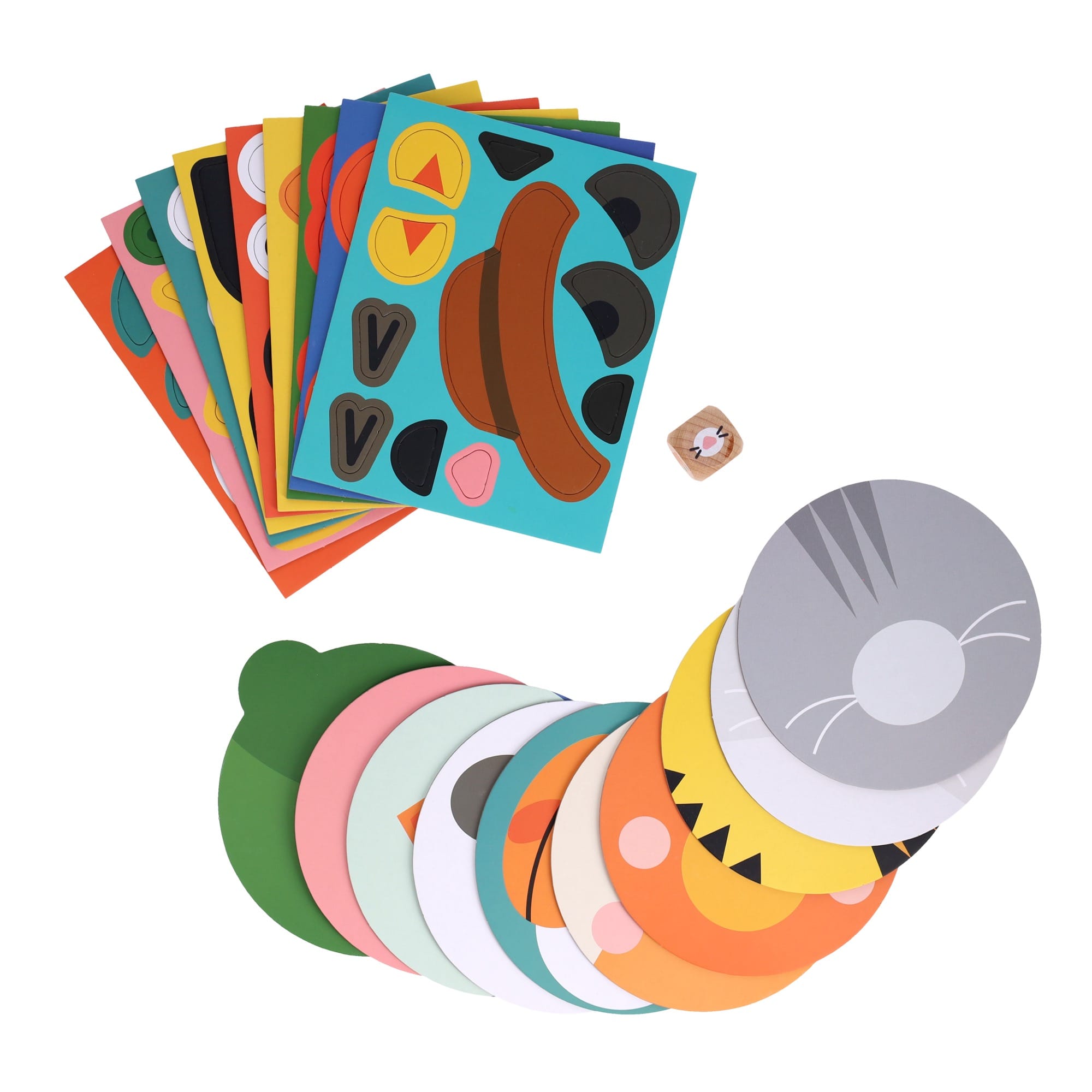The Make Funny Faces Game by Petit Collage features colorful sheets with animal faces, a small die, and round face cutouts arranged on a white surface.