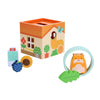 The Petit Collage Petit Pals: Hugo Hamster Wooden Toy features a house-decorated cube with window and flower designs, plus five wooden shapes: hamster, leaf, sunflower, blueberry, and drink.