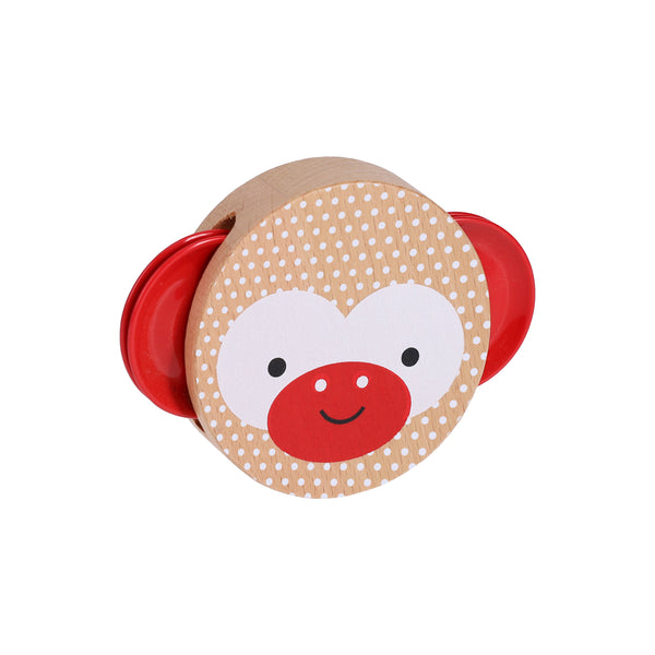 The Petit Collage Shake and Play: Wooden Tambourine features a monkey face with red ears and a red nose on a beige background decorated with white dots.