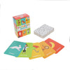 Charades for Kids by Petit Collage features a box, a deck of cards with black-and-white illustrations, and five colorful cards labeled rabbit, doctor, umbrella, bicycle, and banana.