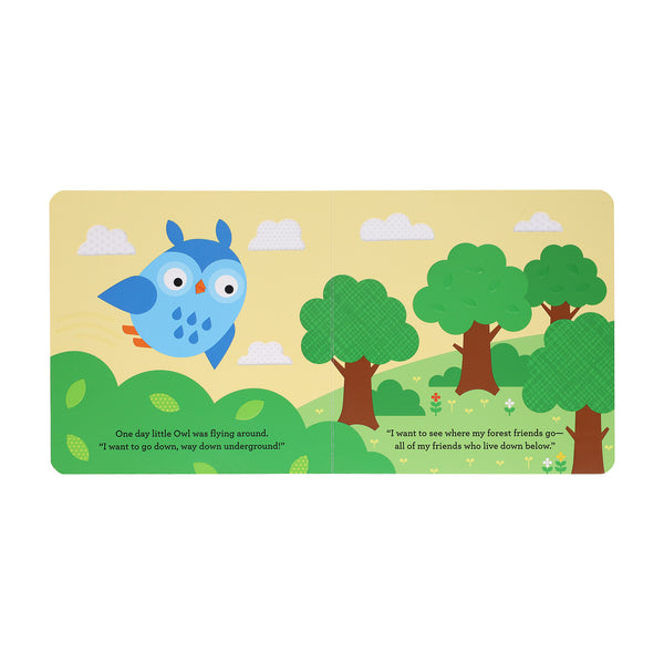 In "A Find and Feel Story: Down, Down, Under the Ground" by Petit Collage, a blue cartoon owl soars above green trees, curious to go underground to meet forest friends.