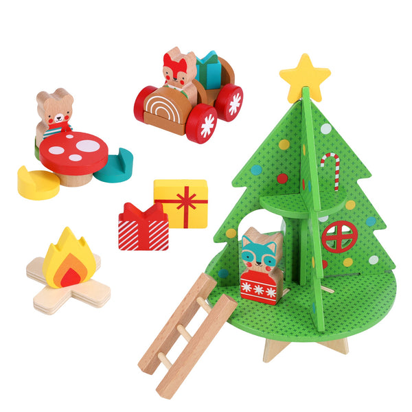 The Petit Collage Christmas Treehouse Wooden Play Set includes a green tree, yellow star, ladder, animal figures, gift boxes, campfire, red car, and a mushroom-shaped table with chairs.