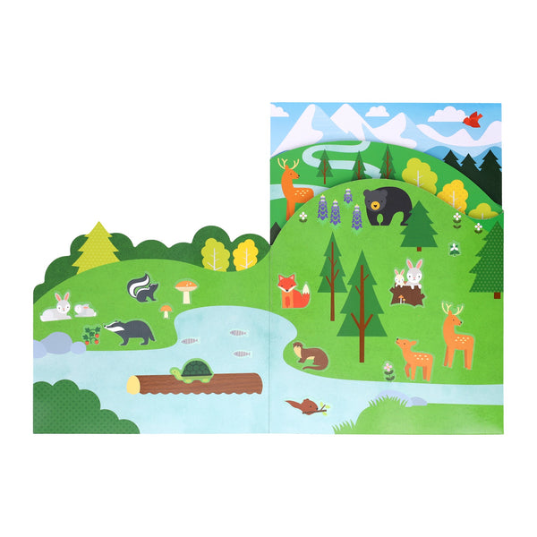 The Petit Collage Sticker Activity Set: Wild Woodland features a colorful scene with mountains, trees, a river, and animals like deer, rabbits, skunks, a bear, foxes, beaver, otter and a cardinal in the sky.