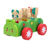 The Petit Collage Bug Bus Wooden Play Set features a green animal-shaped toy car with red wheels, carrying three upright animal figures—a bear, a rabbit, and a cat.