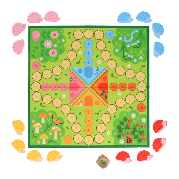 Hurry Home, Hedgehogs! by Petit Collage is a colorful board game featuring a green board with pathways and four sets of pink, blue, yellow, and red hedgehog pieces, plus a die for gameplay.
