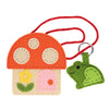 The Petit Collage Mini Craft Kit: Toadstool Purse features a felt mushroom house with a pink door, yellow flower, red cord, and includes a green felt frog keychain.