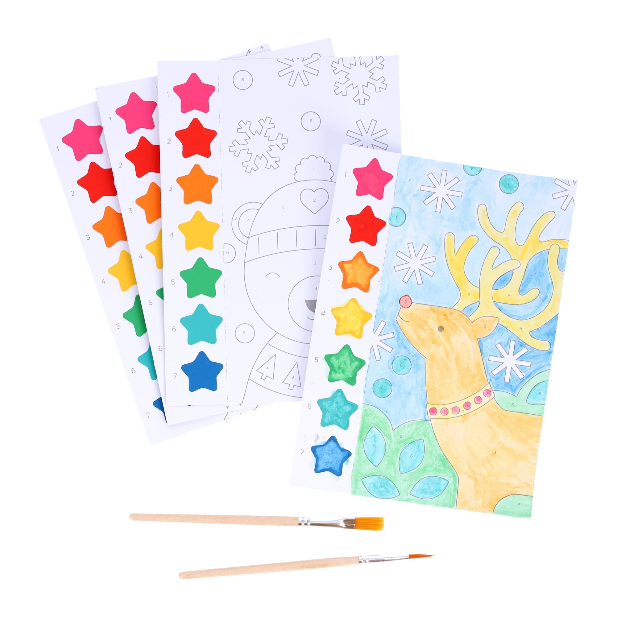 Petit Collage’s Paint by Numbers: Christmas includes four sheets with paint strips and brushes—one pre-painted with a reindeer design, while the other three display uncolored outlines of festive animals and shapes.
