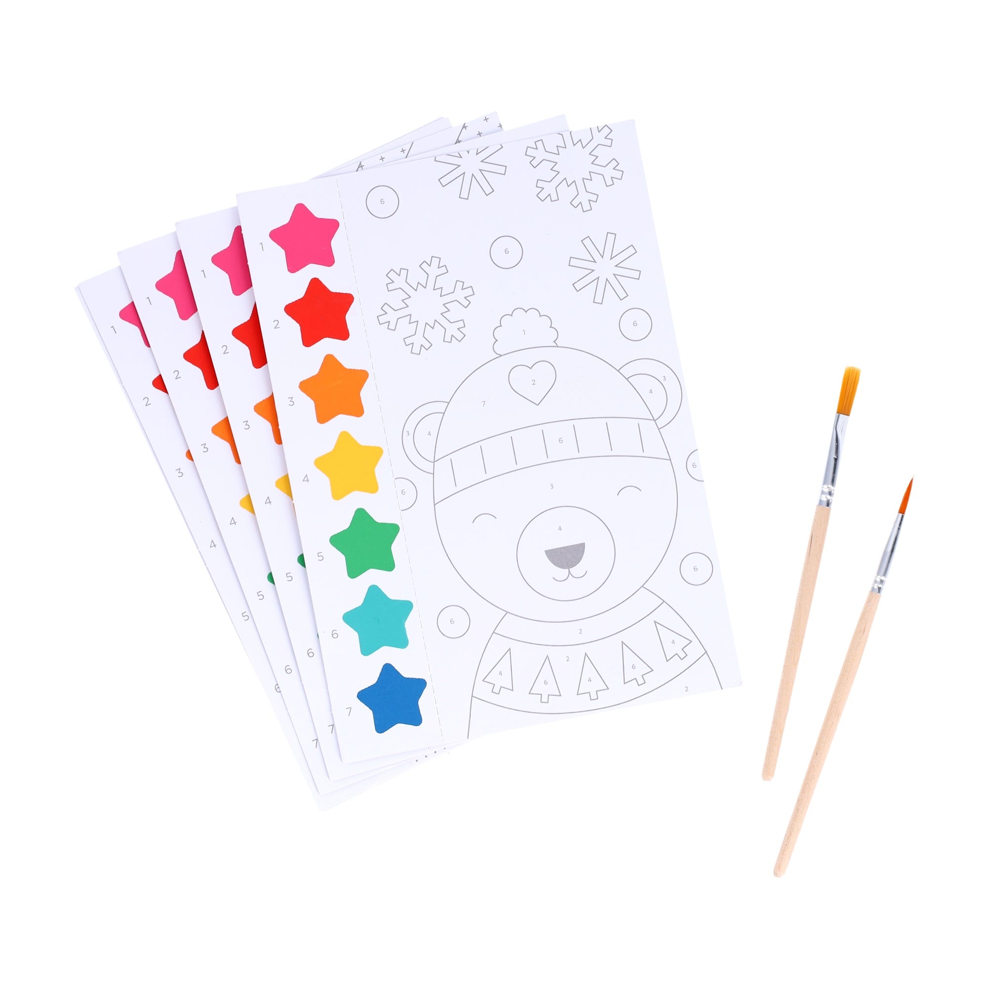 The Petit Collage Paint by Numbers: Christmas set includes five paint-by-number sheets with colorful paint tabs and two brushes, featuring a bear in winter clothing on the top sheet.