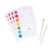 The Petit Collage Paint by Numbers: Christmas set includes five paint-by-number sheets with colorful paint tabs and two brushes, featuring a bear in winter clothing on the top sheet.