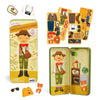 The Petit Collage Dinosaur Discovery Shine Bright Magnetic Play Set includes a metal case, explorer figure, animal magnets, clothing, and fun accessories like hats, glasses, and bags—all with a dinosaur explorer theme.