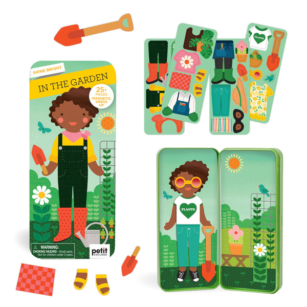 The Shine Bright In the Garden magnetic dress-up set by Petit Collage features a gardener character with mix-and-match gardening outfits and accessories, all stored in a tin box with an illustrated garden backdrop.