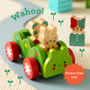 Three wooden animal figures from the Petit Collage Bug Bus Wooden Play Set ride in a green toy bug bus on a playmat track, while another wooden animal figure stands nearby. Text reads “Wahoo!” and “Screen-free fun!”.