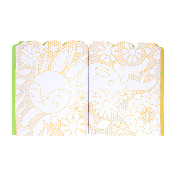 An open Bunnies Coloring Book + Stickers by Petit Collage displays outlined illustrations of a bunny surrounded by flowers and leaves across both pages.