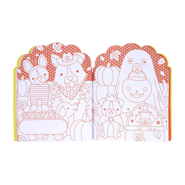 The Petit Collage Dogs Coloring Book + Stickers features open pages with orange outlines of dogs dressed in Halloween costumes—like clowns, alongside rabbits, pumpkins, and ghosts—ready for coloring.