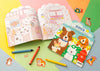 The Petit Collage Dogs Coloring Book + Stickers set is shown open with crayons and loose dog stickers on a colorful background.