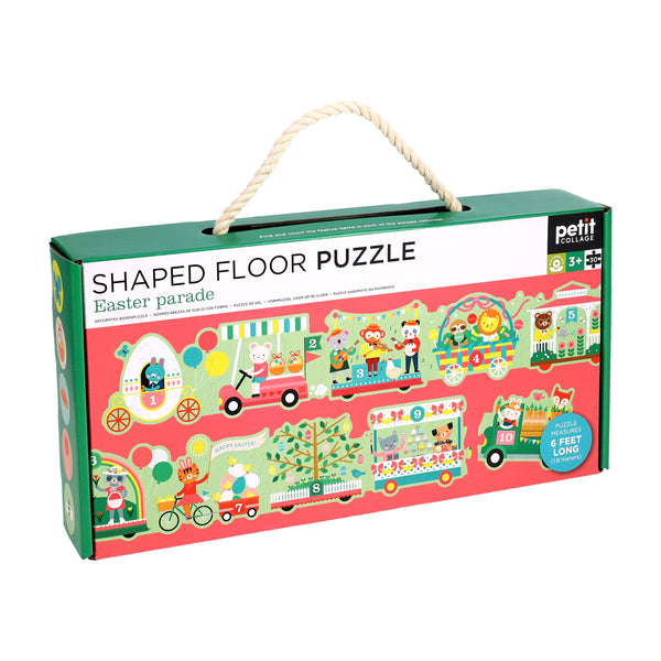 The Petit Collage Easter Parade Shaped Floor Puzzle comes in a rectangular box with a rope handle, features colorful animal illustrations, and is designed for ages 3+.