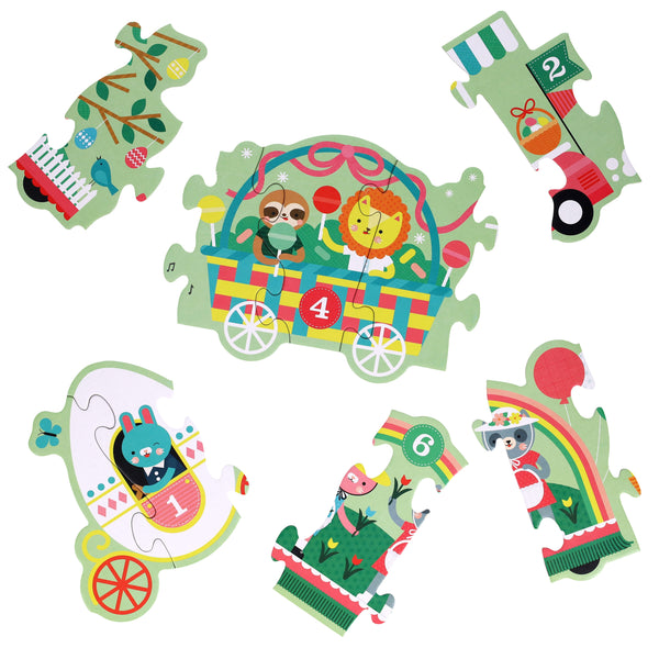 Six vibrant puzzle pieces from the Petit Collage Easter Parade Shaped Floor Puzzle feature circus animals in vehicles, each piece numbered 1 to 6, shown on a white background.