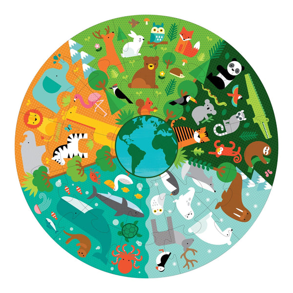 The Petit Collage Floor Puzzle: My Planet Earth features a circular illustration of animals from forest, grassland, ocean, and polar habitats encircling the Earth, with each quadrant representing a unique ecosystem.