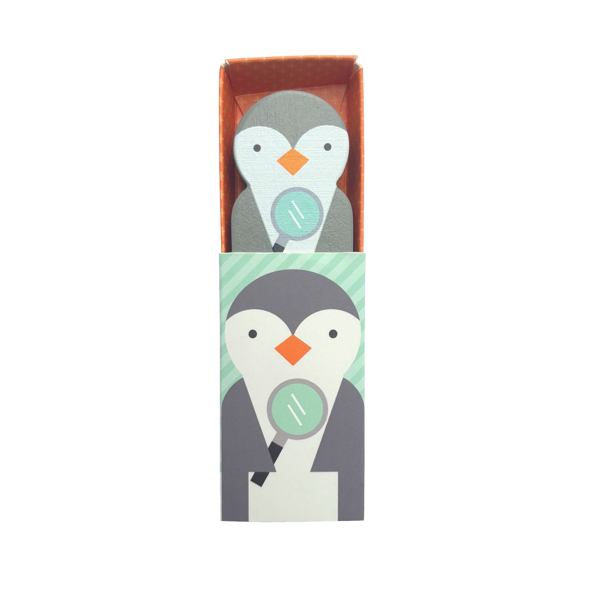 A box featuring Petit Collage’s Wooden Planet Pal: Professor Peggy—a cartoon penguin holding a magnifying glass—with a matching penguin-patterned figure inside the box.