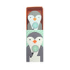 A box featuring Petit Collage’s Wooden Planet Pal: Professor Peggy—a cartoon penguin holding a magnifying glass—with a matching penguin-patterned figure inside the box.