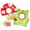 The Petit Collage Toadstool Toss Wooden Cornhole Game includes two colorful targets shaped like a red mushroom and green frog with flower designs, plus two patterned bean bags.