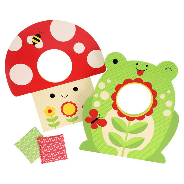 The Petit Collage Toadstool Toss Wooden Cornhole Game includes two colorful targets shaped like a red mushroom and green frog with flower designs, plus two patterned bean bags.