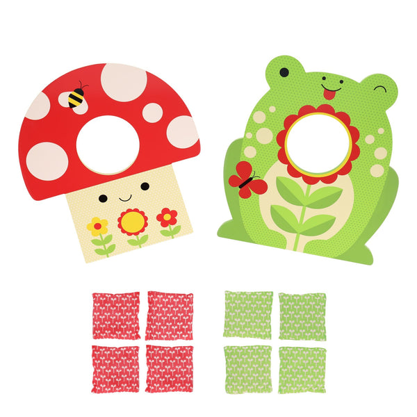 The Petit Collage Toadstool Toss Wooden Cornhole Game includes two boards—a mushroom and a frog—plus six red and six green patterned bean bags neatly arranged below them.