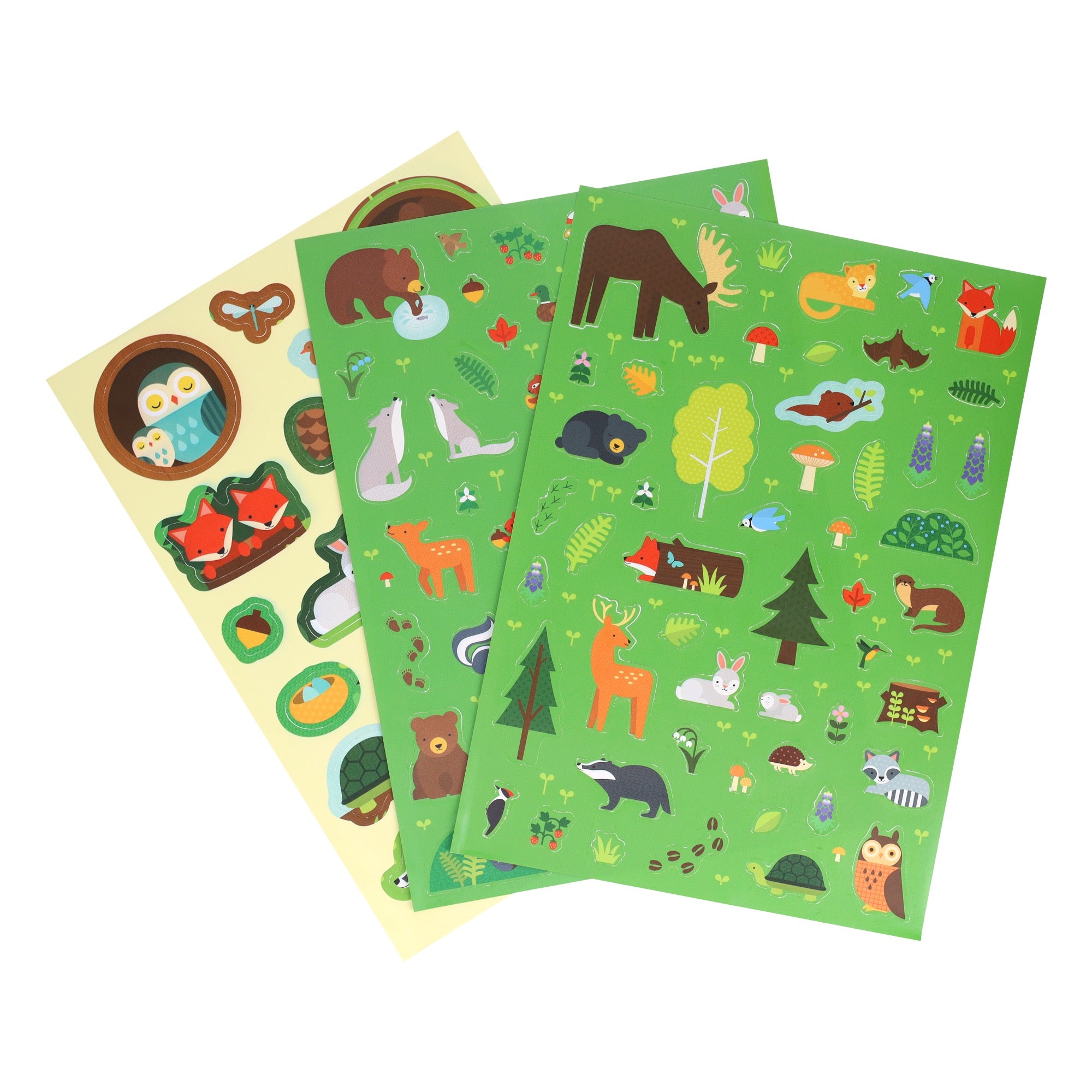 The Petit Collage Sticker Activity Set: Wild Woodland includes three sheets of stickers with colorful woodland animals, trees, mushrooms, acorns, and nature-themed designs on green and yellow backgrounds.